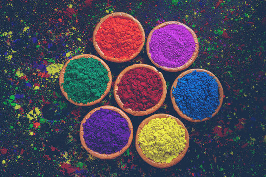 Indian Festival Holi, Colors in wooden bowl on dark background © PRASANNAPIX