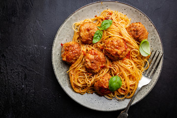 Plate of spaghetti with meatballs in tomato marinara sauce, top view