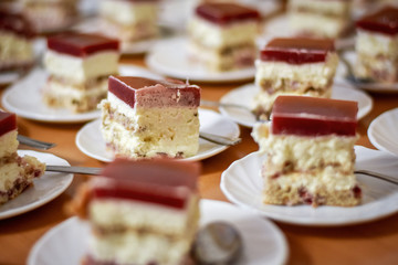 Many cakes with cream and berries, selective focus