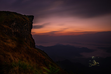 Dawn at Phu Chi Fah with the light from village below