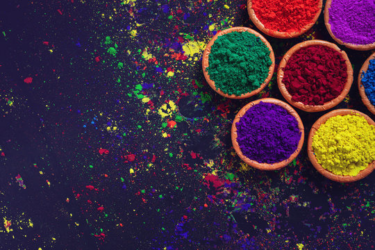 Indian Festival Holi, Colors in wooden bowl on dark background © PRASANNAPIX