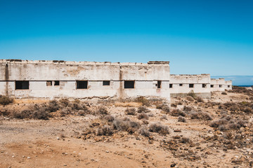 abandoned building ruins in ghost town in desert landscape