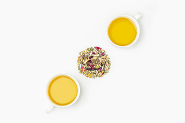 Layout of cup of green tea with assortment of different dry tea leaf and flower petals on a white background. Organic, herbal, detox, vitamin hot drink for tea ceremony. Close up, copy space for text