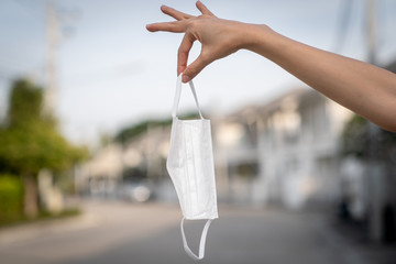 Hands holding protective medical face mask.