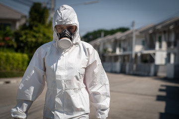 Woman wearing gloves with biohazard chemical protective suit and mask. She crossed her arms with...