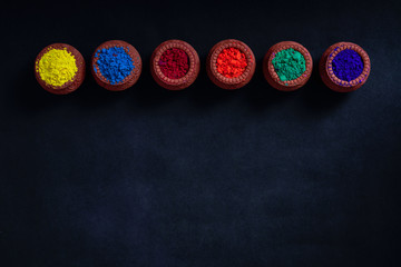 Indian Festival Holi , Colors in wooden bowl on dark background