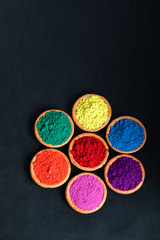 Indian Festival Holi , Colors in wooden bowl on dark background
