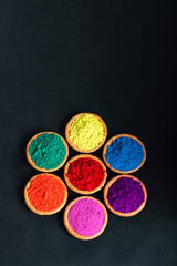 Indian Festival Holi , Colors in wooden bowl on dark background