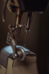 selective focus of needle of sewing machine in workshop