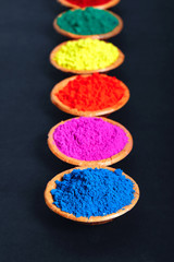 Indian Festival Holi , Colors in wooden bowl on dark background