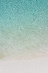 Beach perfect white sand turquoise water top view, aerial landscape, calm sea waves and clear water view