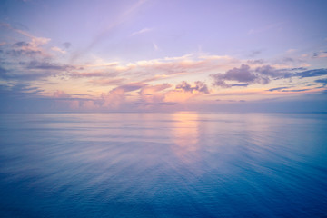 Aerial panoramic view of sunset over ocean. Nothing but sky, clouds and water. Beautiful serene scene