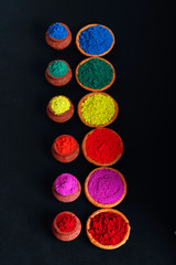 Obraz na płótnie Canvas Indian Festival Holi , Colors in wooden bowl on dark background