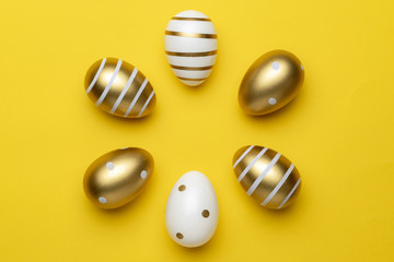 Easter basket. golden shine decorated eggs in basket isolated on yellow background. Greeting card trendy design.