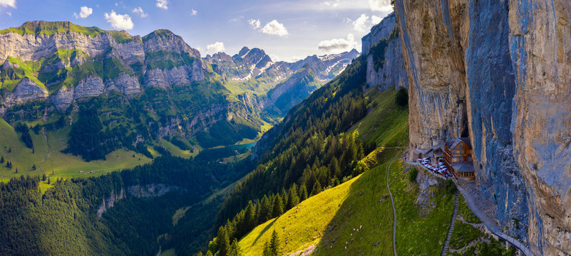 Swiss Alps and a restaurant under a cliff on mountain Ebenalp in Switzerland