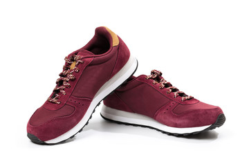 a pair of new burgundy, cherry sneakers or athletic shoes isolated on a white background.