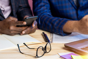 Two businessmen speaking and working at the office