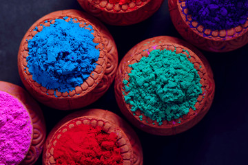 Indian Festival Holi , Colors in wooden bowl on dark background