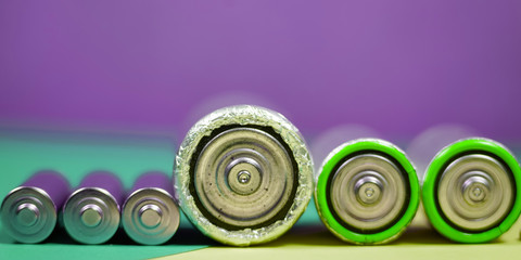 Many different types used or new battery, rechargeable accumulator, alkaline batteries on color...