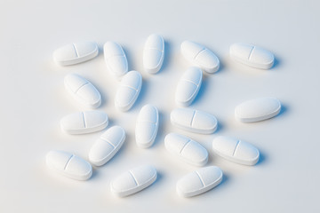 white pills on white background with blue lights