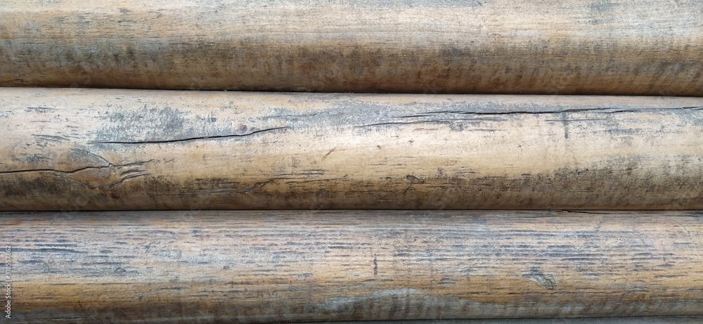 Poster round timber assortment. fragment of the construction of rounded wooden logs. the effect of moisture
