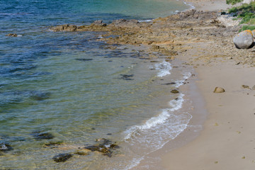 beautiful tropical sea beach with stones on the shore