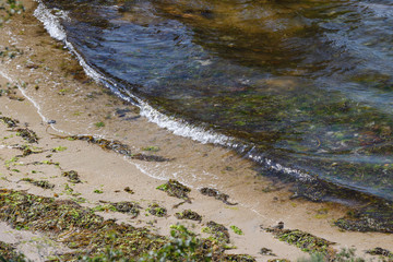 beautiful tropical sea beach with stones on the shore