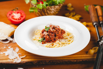 Spaghetti bolognese with tomato sauce, minced meat and grated parmesan cheese. Italian pasta.