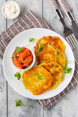 Fried potato pancakes with salmon and sour cream, fritter, roesti, golden crispy crust. Traditional delicious food