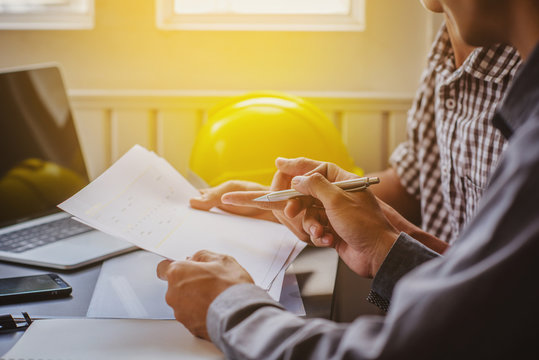 Two young engineers are working on consultations.