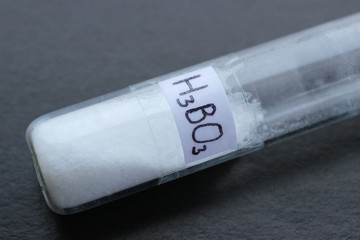 Weak, inorganic boric acid of crystalline structure in test tube. It is most used in medicine, nuclear energy, conservation, electrocoating, and as an boron micro fertilizer.