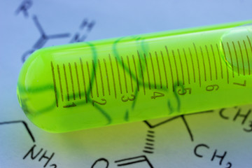Organic green fluorescent dye in a measuring test tube.