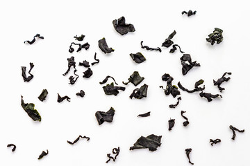 Dry wakame seaweed isolated on white background. Heap of dried kombu algae, traditional Japanese ingredient for cooking Dashi soup