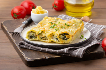 Italian cannelloni pasta with ricotta and spinach, traditional delicious food with cheese