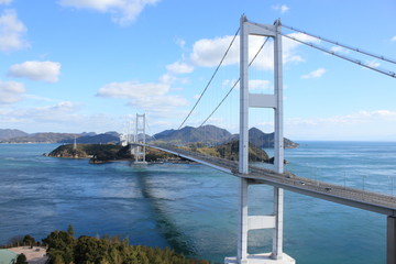 Stylish bridge across on the blue beautiful ocean in Japan