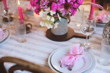 Obraz na płótnie Canvas summer festive table details in pink, white and purple tones. Family romantic dinner or party in rustic country house.