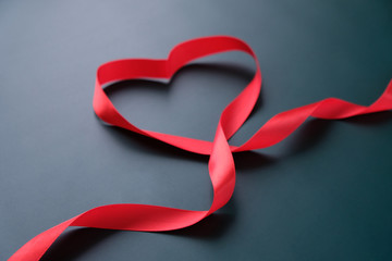 red ribbon in the shape of a heart