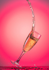 splash in a falling champagne glass on a color yellow gradient background
