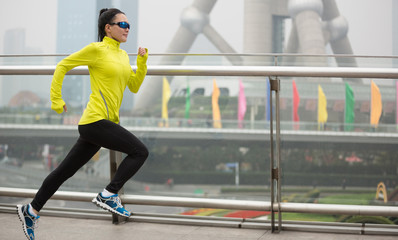 Young fitness woman runner running at shanghai city