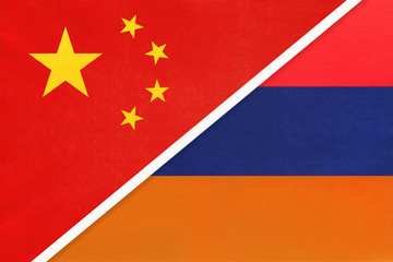China or PRC vs Armenia national flag from textile. Relationship between asian and european countries.