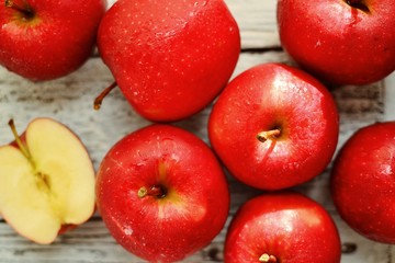 Fototapeta na wymiar Red apples on a wooden background. Healthy ripe fruits, raw food diet, vegetarian.