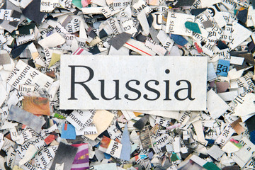 Newspaper confetti from above with the word Russia