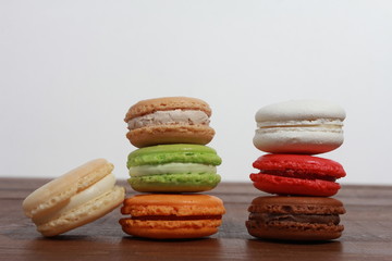 Stack of macaroons on dark wooden table. Dessert concept. Set, snack, confection, macaron cake, cuisine, side view