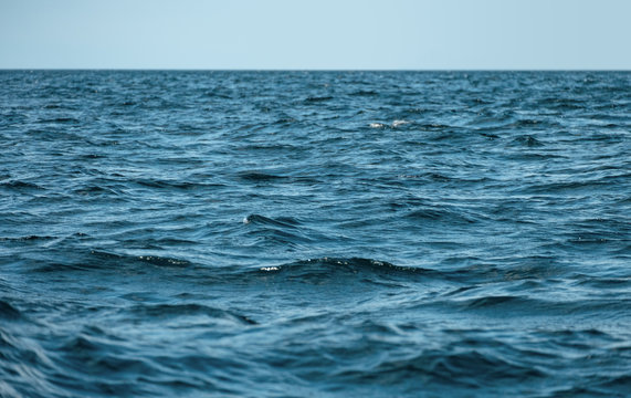 Waves on ocea with clear blue sky