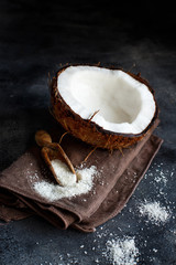 Coconut flour in a wooden spoon close up