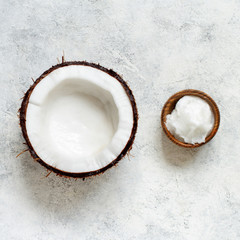 Coconut oil in a bowl and half of coconut