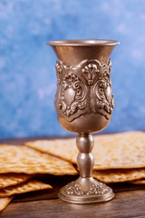 Jewish silver cup with wine with matzos. Passover concept.