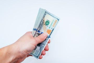 Hand holding dollars on white backgrounds. Isolated