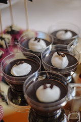 Close up of tray with lot delicious diversity pastry cakes tartlets and macaroon in a row. Fresh, multicoloured, colourful, green, yellow, white and pink sweet berry desserts, beautifully decorated