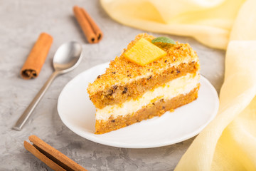 Homemade cake with persimmon and pumpkin and a cup of coffee on a gray concrete background. side view, selective focus.
